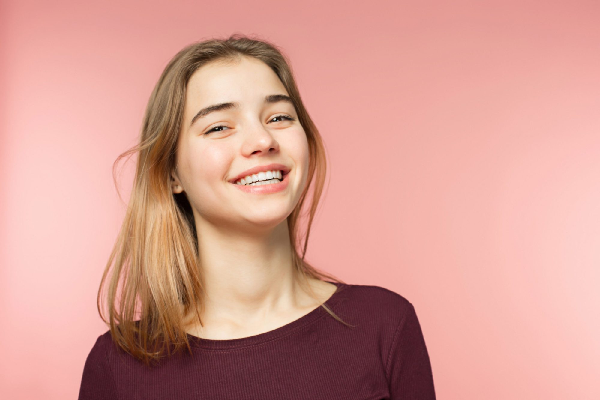 teenager smiling and looking at camera